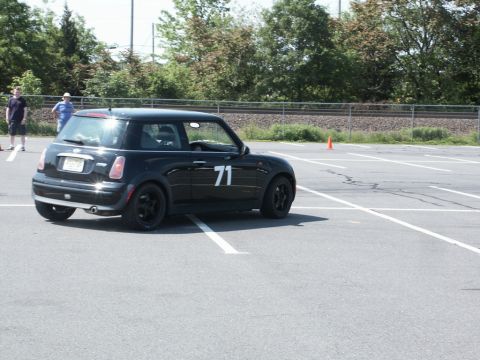 2001 Mercury Grand Marquis - Photo of a black Mini Cooper, number 71, at an autocross event with spectators nearby.