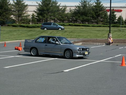 2001 Mercury Grand Marquis - Photo of a silver BMW E30 M3 turning through cones at an autocross event.