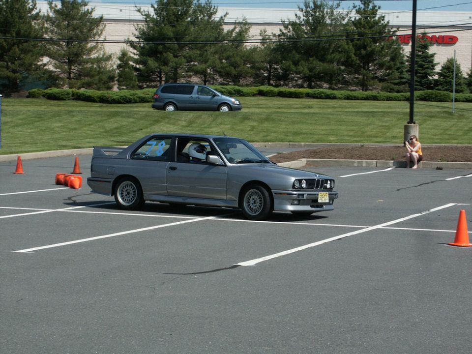 Silver BMW E30 M3 cornering at a parking-lot autocross