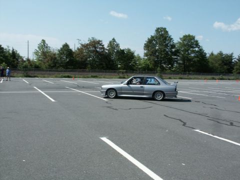 2001 Mercury Grand Marquis - Photo of a silver BMW E30 M3 running an autocross course lined with traffic cones.