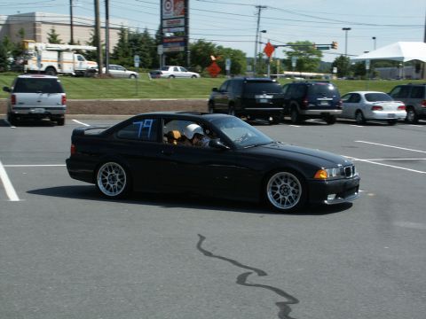 2001 Mercury Grand Marquis - Action photo of a black BMW E36 coupe, number 79, cornering at an autocross event.