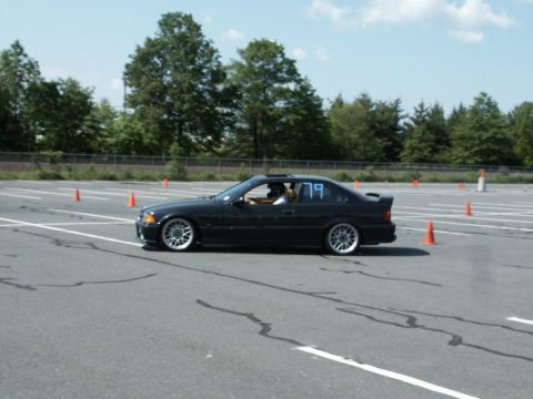 2001 Mercury Grand Marquis - Photo of a black BMW E36 coupe, number 79, running an autocross course lined with cones.
