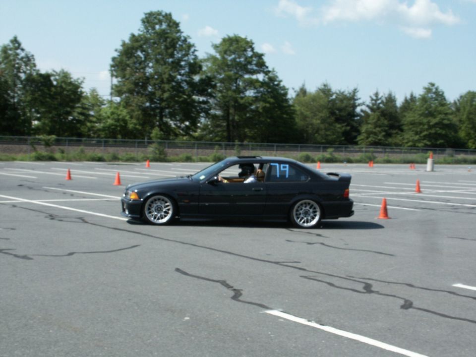 Black BMW E36 coupe number 79 on an autocross course
