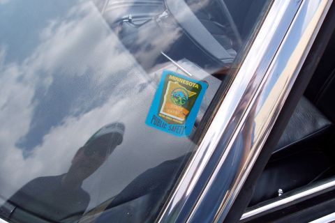 2001 Ford Crown Victoria - A Minnesota State Patrol sticker is affixed to the inside of a car's windshield. The sticker is blue and features the Minnesota state outli…