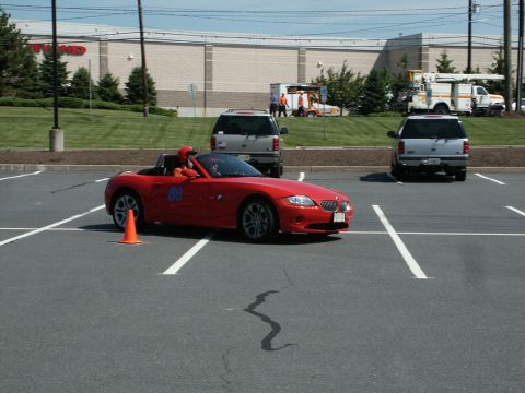 2001 Mercury Grand Marquis - Photo of a red BMW Z4 roadster, number 88, at an autocross event in a parking lot.