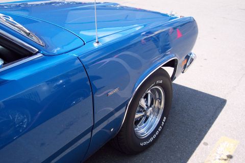 2001 Ford Crown Victoria - Blue classic car fender detail with Valiant badge and chrome wheel.