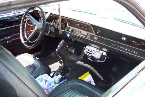 2001 Ford Crown Victoria - The interior of a Plymouth shows its dashboard, steering wheel, and seats, with a stick shift in the center console.