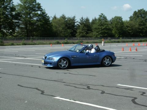 2001 Mercury Grand Marquis - A blue convertible is driven on a course marked with cones, with a driver wearing a helmet.