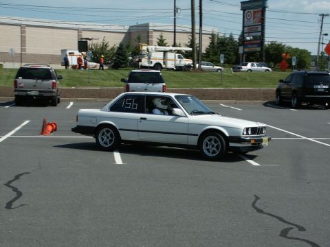 2001 Mercury Grand Marquis - A white BMW coupe with racing number 156 participates in an autocross event.