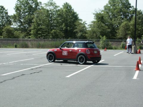 2001 Mercury Grand Marquis - A red Mini Cooper with a black roof and racing number 172 on its door navigates an autocross course.