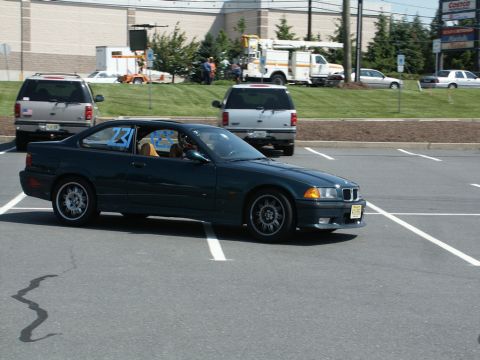 2001 Mercury Grand Marquis - BMW E36 coupe with racing numbers visible in a parking lot during an event.