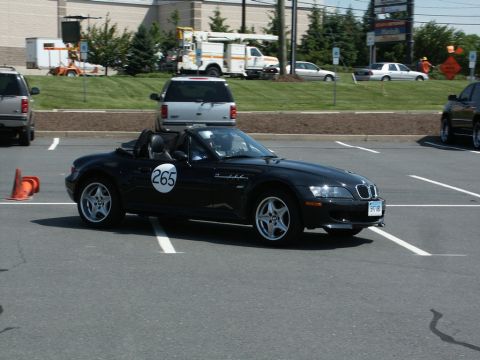 2001 Mercury Grand Marquis - A black convertible sports car, identified by racing number 265, is parked in a lot.