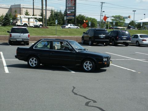 2001 Mercury Grand Marquis - A black coupe is parked in a lot with other vehicles visible in the background.