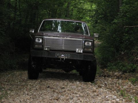 1980 Ford Bronco - This 1980 Ford Bronco navigates a wooded gravel path, its classic front-end design.