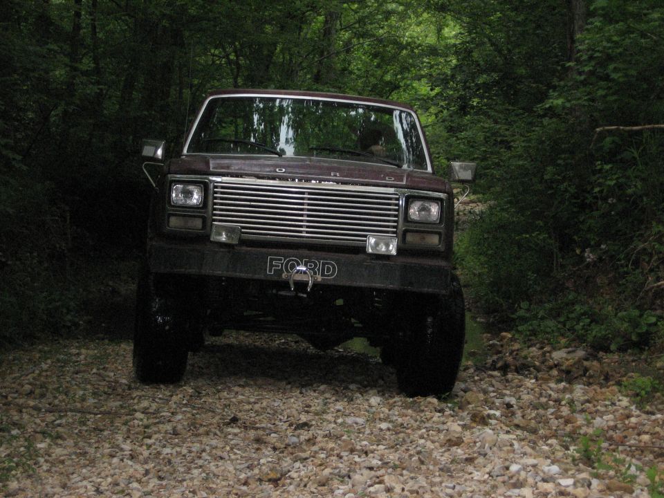 Brown 1980 Ford Bronco front view on gravel road