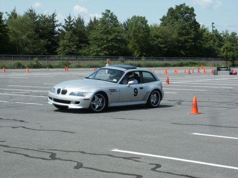 2001 Mercury Grand Marquis - A silver BMW Z3 Coupe navigates an autocross course marked by orange cones.