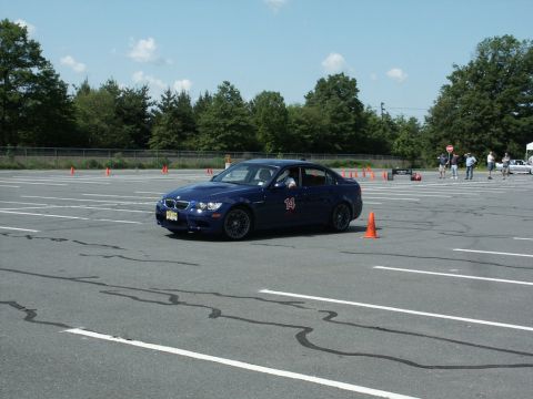 2001 Mercury Grand Marquis - A blue sedan navigates an autocross course marked by orange cones.