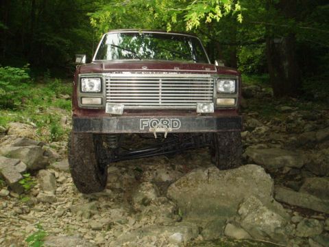 1980 Ford Bronco - This Ford Bronco is navigating a rocky, wooded trail.