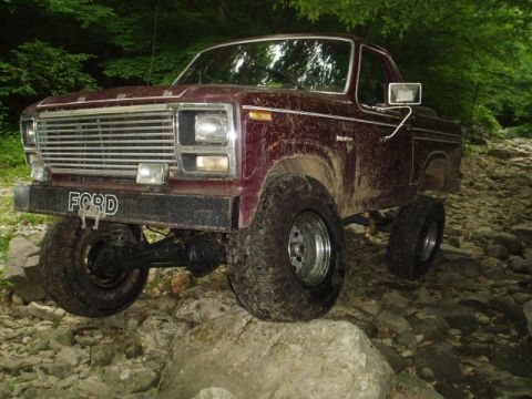 1980 Ford Bronco - This lifted Ford Bronco is navigating a rocky, off-road trail.