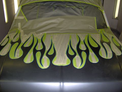 1987 Ford Bronco - A car hood is prepped for painting with flame decals applied using masking tape.