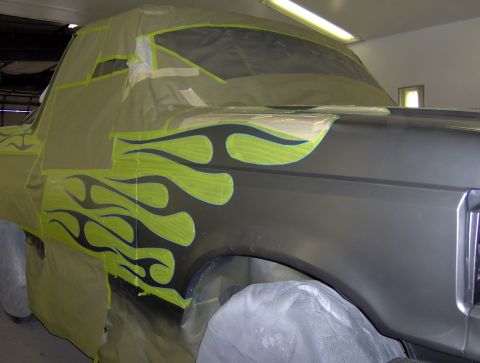 1987 Ford Bronco - Truck fender masked off for custom flame paint job, likely a 1987 Ford Bronco.