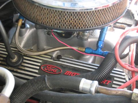 1988 Mercury Grand Marquis - A close-up view of the engine bay of a Ford vehicle, showing the carburetor, air filter housing, and valve cover with "Ford" branding. Visi…