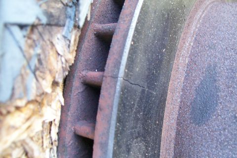 1992 Ford C-350 (Centurion Conversions) - Close-up of a cracked brake rotor, showing rust and wear.