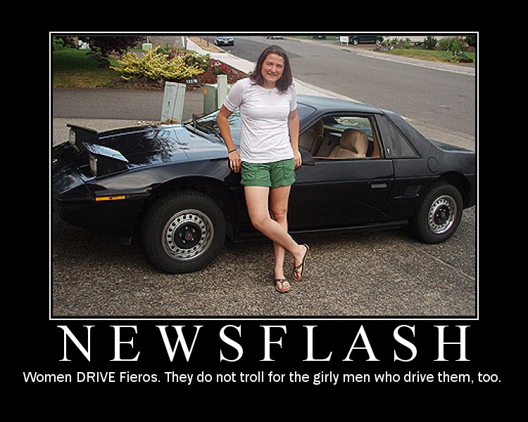 Woman standing next to a black Pontiac Fiero coupe