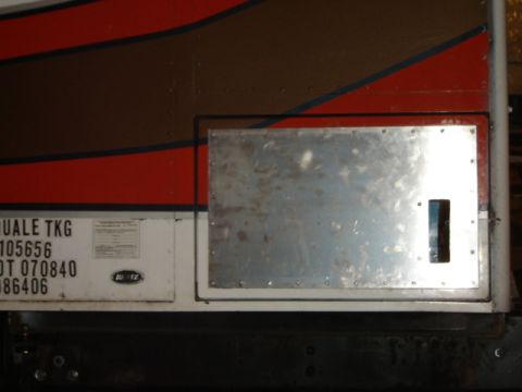 1992 Ford Bronco - Photograph of a truck or trailer side with an access door and small data label, not a document scan.