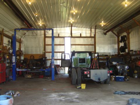 1992 Ford Bronco - Photograph of a repair shop interior with vehicles in progress, not a technical document.
