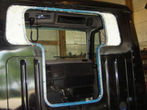 1992 Ford Bronco - Photograph of a truck cab interior viewed through the rear window opening, not a technical document.