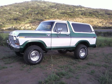 1978 Ford Bronco - This 1978 Ford Bronco is white with green accents and sits on off-road tires.
