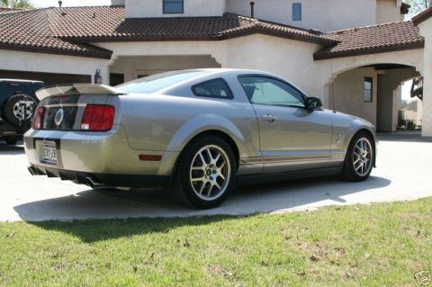 2008 Ford Mustang - A silver Ford Mustang is parked in front of a house.
