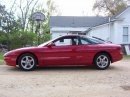 1993 Ford Probe coupe, side view. Red paint, alloy wheels