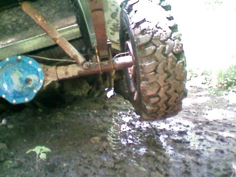 1980 Dodge Magnum - Vehicle stuck in mud, showing close-up of tire and suspension parts.