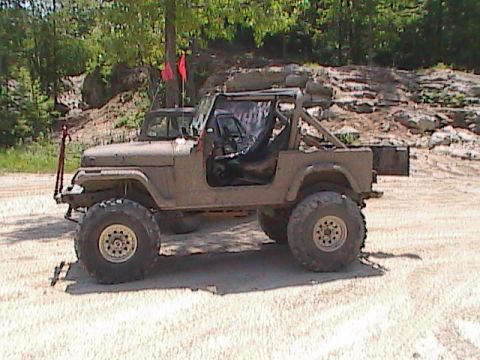 1980 Dodge Magnum - This off-road Jeep is covered in mud and features large tires and a prominent roll cage.