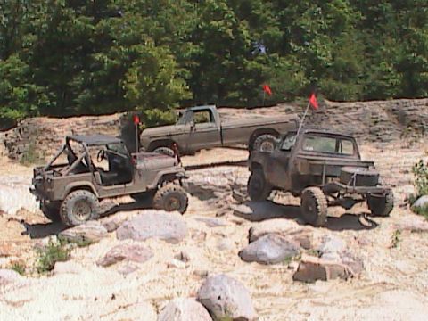 1980 Dodge Magnum - Multiple off-road vehicles are seen in a natural, rocky environment.