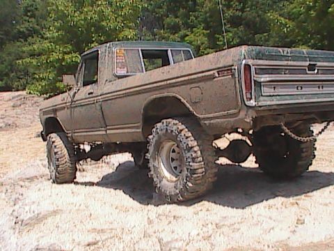 1980 Dodge Magnum - This heavily modified pickup truck is covered in mud and equipped with large tires for off-road use.
