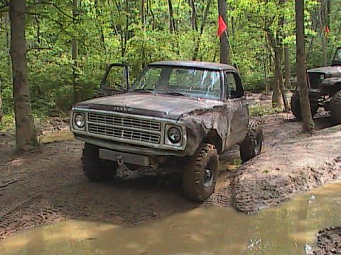 1980 Dodge Magnum - A muddy 1979 Dodge pickup truck navigates an off-road course, with another vehicle visible in the background.