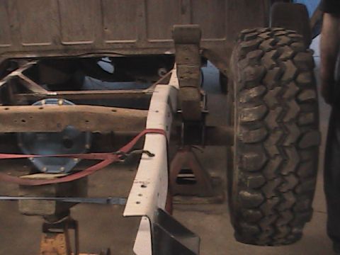 1980 Dodge Magnum - The rear suspension and frame of a truck are shown, supported by jack stands.