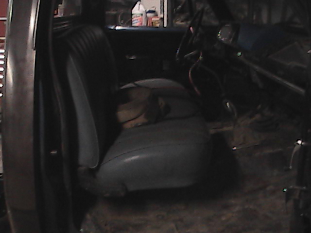 Interior view of a pickup truck showing the driver's seat and dashboard
