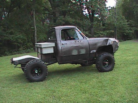 1980 Dodge Magnum - This modified pickup truck features a flatbed conversion, a toolbox mounted behind the cab, and oversized off-road tires.