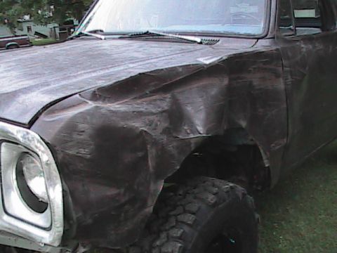1980 Dodge Magnum - Front fender and hood of a truck show significant damage from an impact.