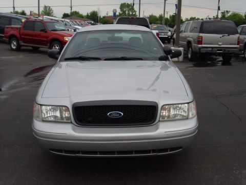 2004 Ford Crown Victoria - Silver Ford Crown Victoria parked in a lot with other vehicles visible in the background.