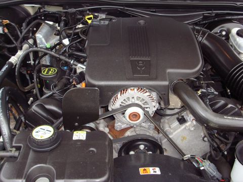 2004 Ford Crown Victoria - Close-up view of a vehicle's engine bay, showing various mechanical components and wiring.