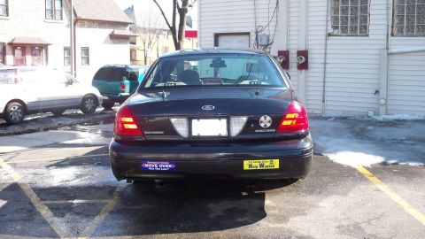 2000 Ford Crown Victoria - This Ford Crown Victoria has a 'Move Over' and a 'Help Wanted' bumper sticker on its rear.