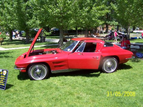 1972 Ford Ranchero - A red 1963 Corvette Sting Ray coupe is displayed with its hood open at an outdoor car show.