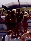 1971 Ford Bronco - People are socializing outdoors near a large building or structure.