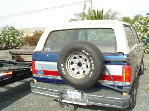 1991 Ford Bronco - The rear of a 1991 Ford Bronco is shown with a spare tire mounted on the tailgate.