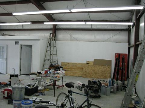 1993 Ford Bronco - This workshop scene contains various items including tools, lumber, and a bicycle, but no visible vehicle.